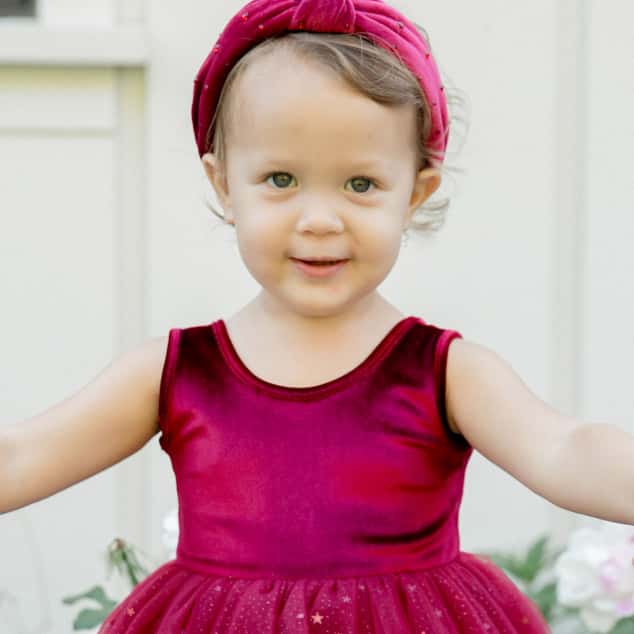 Baby in Maroon Dress Smiling - Baby Category