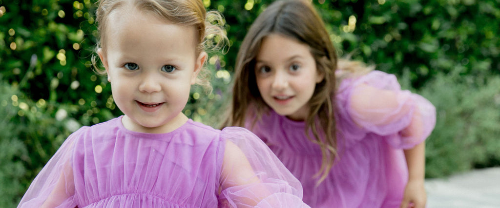 Toddler and Girl in Matching Purple Dresses - How It Works Desktop Banner