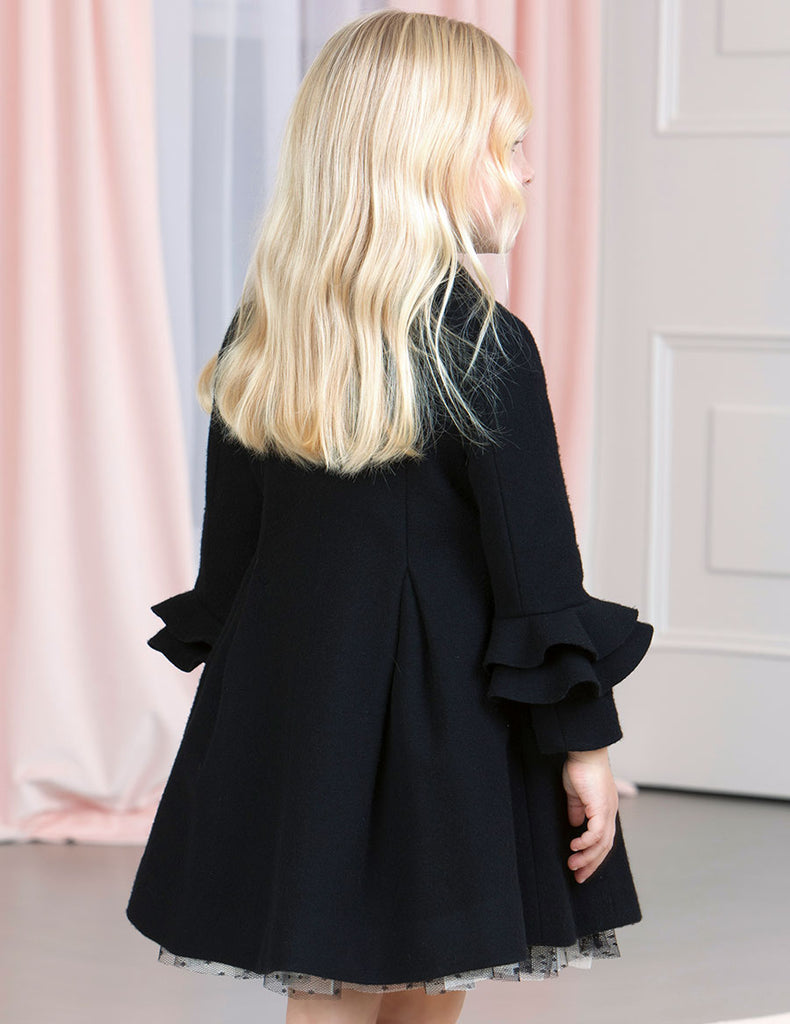 Lookind at the back of Abel & Lula Black Coat with Girls Blonde Hair Draped Down