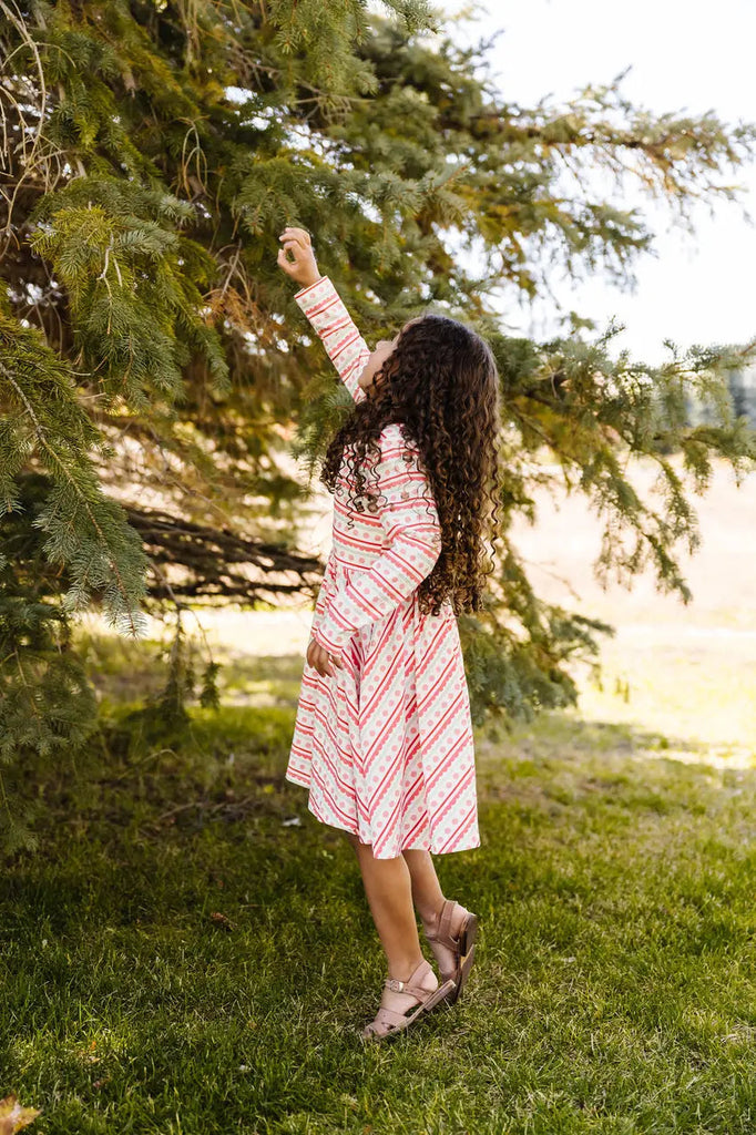 Little Girl reaching the tree.