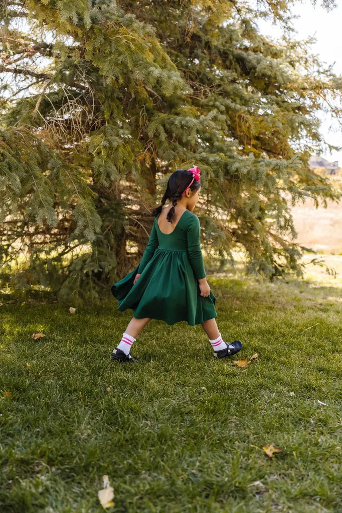 Little Girl walking around wearing Gwendolyn Dress in Evergreen 