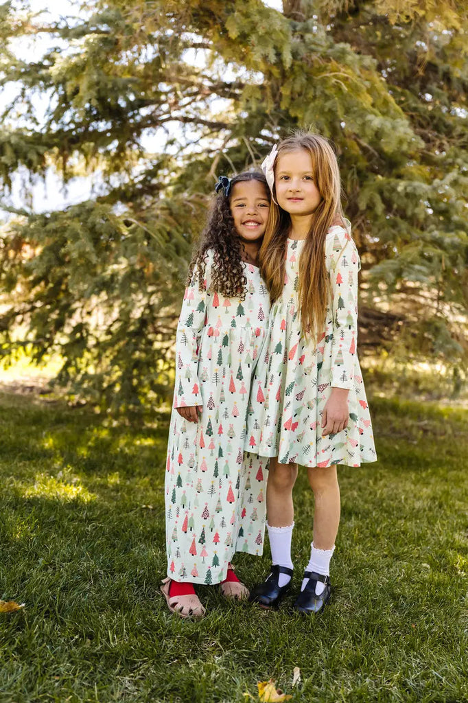 Two Little Girls Posing in wearing matchy outfits.