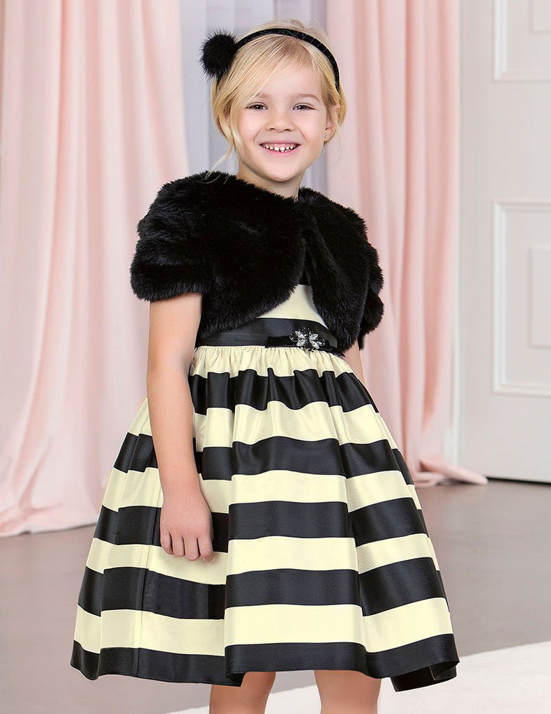 Little Girl Smiling Wearing the Abel & Lula Little Girls Fur Bolero Cardigan, Black and Her Yellow and Black Striped Dress