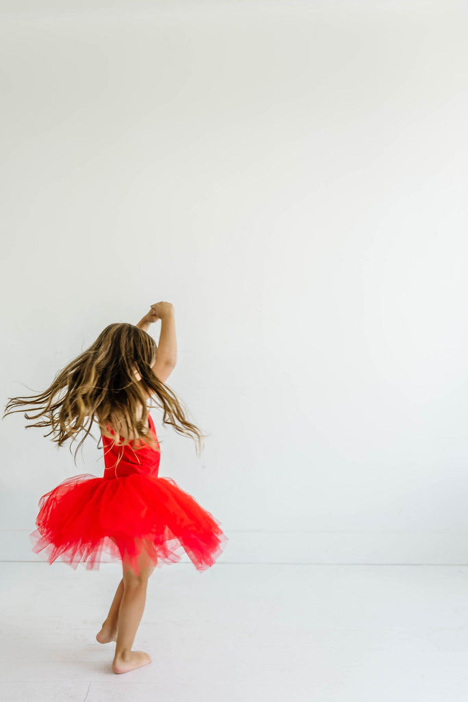 Little Girl in Red Tutu Dress in a Ballerina pose 
