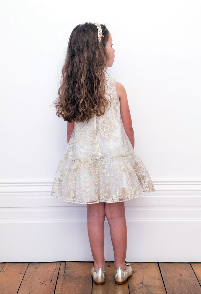 Little Girl posing her Back wearing David Charles Floral Swing Dress.