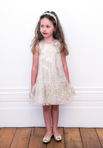 Little Girl Looking to side wearing David Charles Floral Swing Dress.