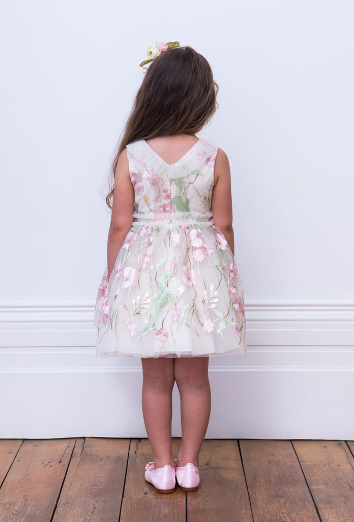 Little Girl Posing her Back wearing David Charles Floral Dress.
