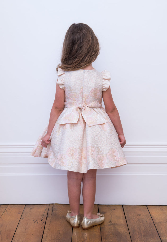 Little Girl posing her back Wearing David Charles Pink Brocade Dress.