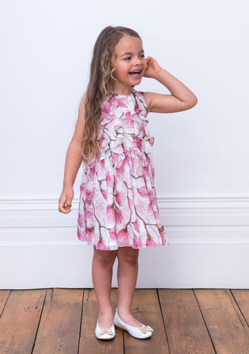 Little Girl Laughing wearing her David Charles Ivory and Pink Peony Tea Dress.