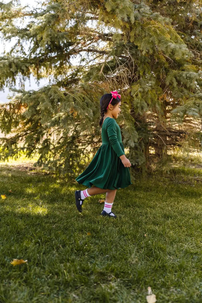 Little girl walking around the trees..
