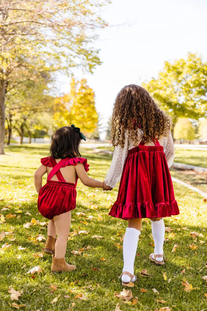Two Little Girls Holding each other while Walking 